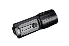 Fenix LR35R rechargeable LED flashlight emitting bright light, black body with adjustable focus, high lumen output, outdoor use.