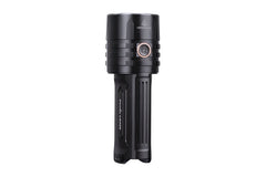 Fenix LR35R rechargeable LED flashlight with 10,000 lumens, black body, and adjustable focus, held in hand.