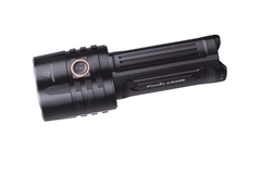 Fenix LR35R rechargeable LED flashlight emitting bright 10,000 lumens, black body with textured grip and adjustable focus.