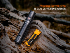 Fenix PD36R V2 compact rechargeable tactical flashlight emitting bright 1700 lumens, with a black body and textured grip.