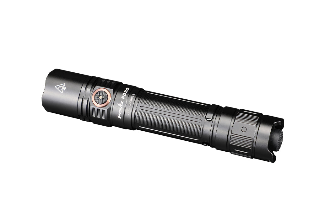 Fenix PD35 V3.0 tactical flashlight in tropic green, showing its compact design and textured grip with lens and control button.